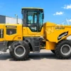 Massive MSD50 Site Dumper In Mozambique - Tractors for Sale in Mozambique Yellow heavy-duty dump truck (MSD50) parked outdoors in a concrete lot under a blue sky with a warehouse nearby.